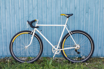 Fototapeta na wymiar speed bike, road bike, against a blue wall