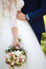 young and beautiful bride and groom enjoy each other. wedding couple enjoying romantic moments outside.