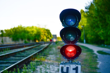 a long railway and red traffic light