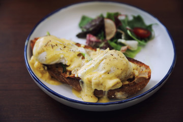 Egg benedict , poached eggs with toast on wood background , English Breakfast
