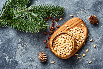 Peeled pine nuts on gray background. Top view.