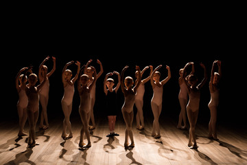 A large group of children rehearsing and dancing the ballet