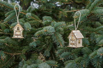 toy little house lamp hanging on a christmas tree.