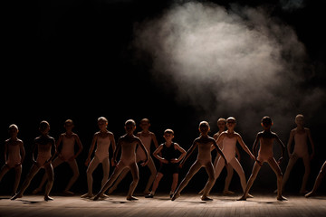 Young ballerinas rehearsing in the ballet class. They perform different choreographic exercises and...