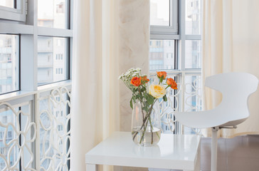 roses in vase on white table