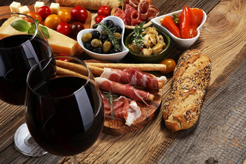 Italian antipasti wine snacks set. Cheese variety, Mediterranean olives, crudo, Prosciutto di...