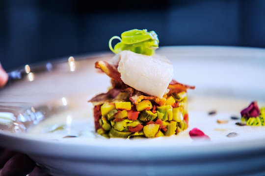 Modern food stylist decorating meal for presentation in restaurant. Closeup of food stylish. Restaurant serving