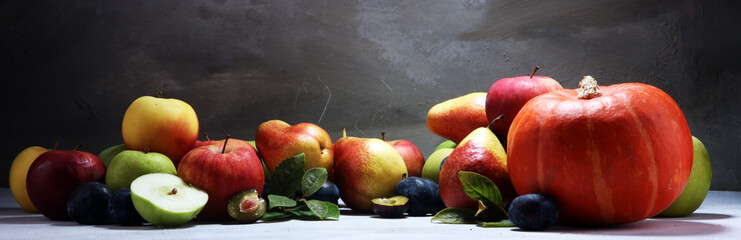 Various fresh fruits. Thanksgiving pumpkin, apples, and maize on rustic background.