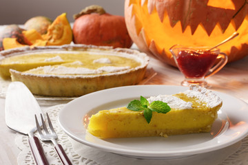 Pumpkin cake, cooked for the celebration of Halloween and decorated with mint twig. Food photography