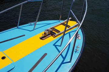 Fototapeta na wymiar Bow of a blue pleasure yacht against sea.