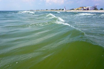 Sea waves with summer beach travel camp on a background with indian teepee © MichaelPervak