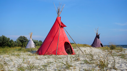 Three Indian wigwams lodge or teepee at the seashore at summer. travel concept. copyspace © MichaelPervak