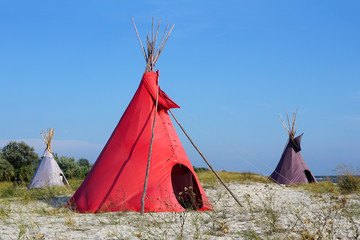 Three Indian wigwams lodge or teepee at the seashore at summer. travel concept. copyspace