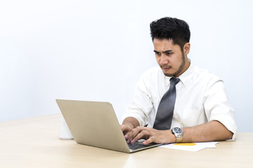 Fototapeta premium Young businessman is 20-30 years old strain and worry at office.Man hands typing on computer keyboard .Copy space.