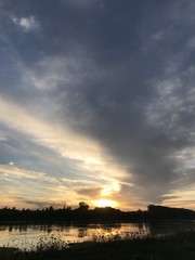 sunset sky sun clouds water nature landscape beauty sunrise red gray blue river morning orange air season summer romance light clouds