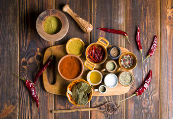 Kitchen spices on a wooden background