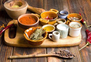 Kitchen spices on a wooden background