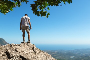 Man Standing on Mountain Top