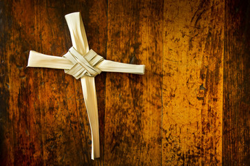 Good Friday Cross Made From Easter Palm Sunday Branch on Old Wooden Bench