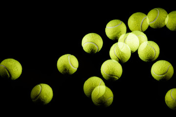 Movement or bounce of tennis ball isolated on black background.