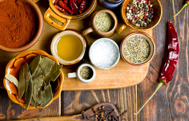 Fototapeta na wymiar Kitchen spices on a wooden background