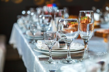 Table setting with glasses, plates, napkins and food
