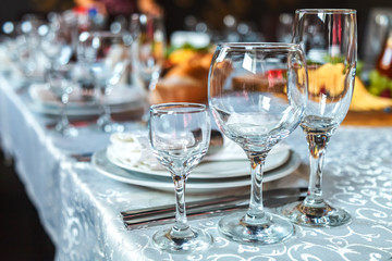Table setting with glasses, plates, napkins and food