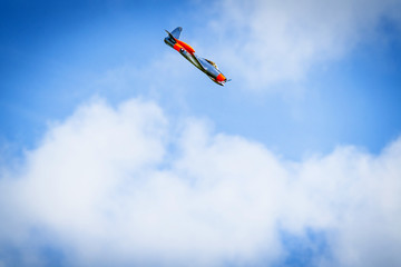 Naklejka na ściany i meble Plane diving on a blue sky