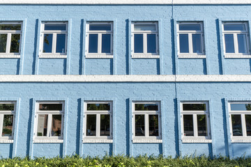 Blue brick house with white windows