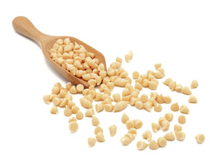 White chocolate chips with wooden spoon on white background.