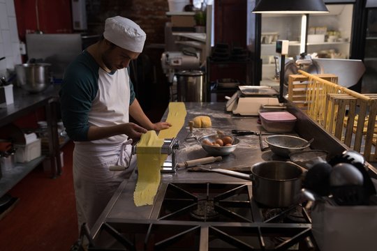 Male chef preparing pasta in the kitchen