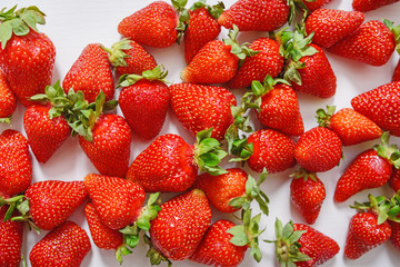 Fresh strawberry. Strawberries on white concrete background. Harvest of organic local strawberries