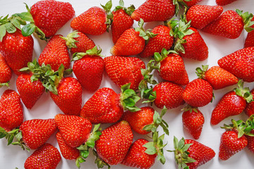 Fresh strawberry. Strawberries on white concrete background. Harvest of organic local strawberries