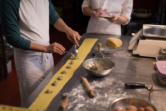 Midsection of chef preparing food in kitchen