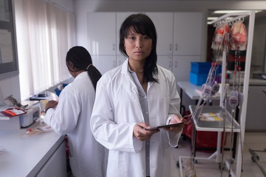 Laboratory technician using digital tablet