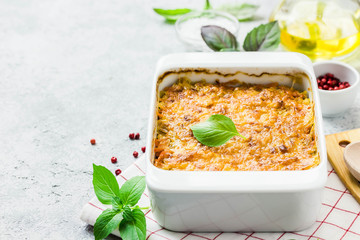 Cheddar cabbage roll casserole on concrete background. Selective focus, space for text.