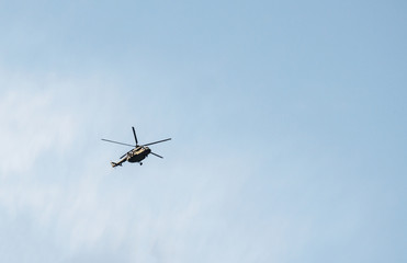 Fototapeta na wymiar against a blue sky flying a helicopter