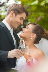 Portrait of a Smiling Wedding Couple Holding Champagne Glasses