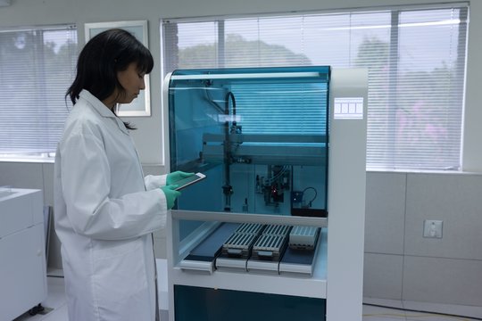 Laboratory technician using digital tablet