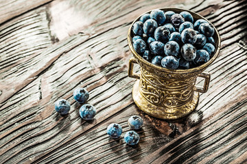 Fresh blueberries in vintage metal bowl