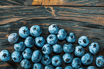 Heap of bilberries on wooden board