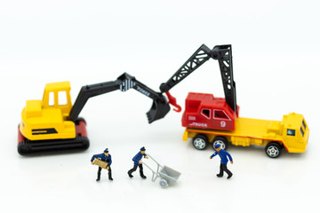 Miniature people: Workers help to moving crates for building home . Image use for construction, business concept.