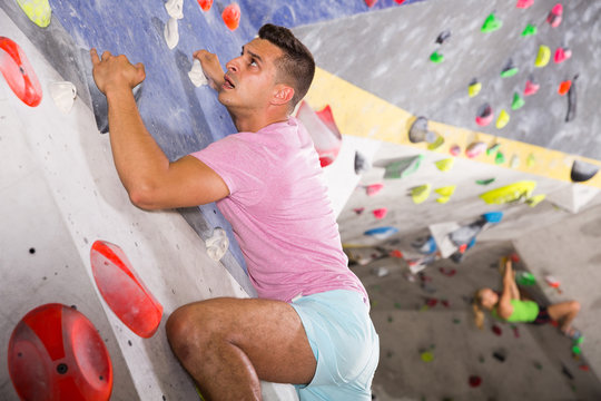 Man training at bouldering gym