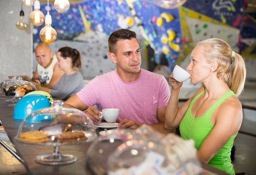 Couple drinking coffee at bouldering gym