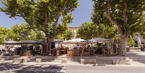 Village square with fountain and restaurant of Maussane les Alpilles. Buches du Rhone, Provence, France