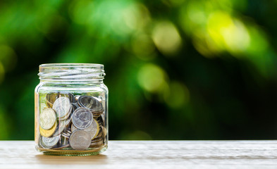 Money coin in glass jar for savings and financial investment concept