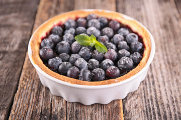 blueberry tart on wood background