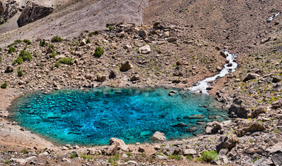 Alaudin lake Bowl in Fann mountains. Small mountain lake with clear water. Tajikistan, Central Asia