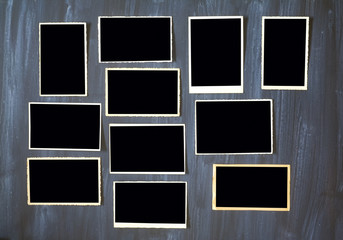 old empty photo frames, vintage photo prints on grungy background with free space for pictures