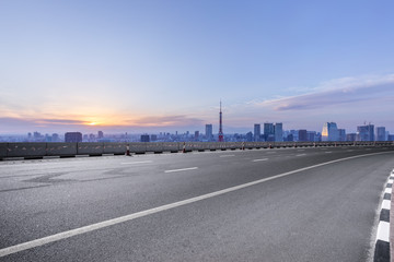 empty asphalt road with city skyline in japan